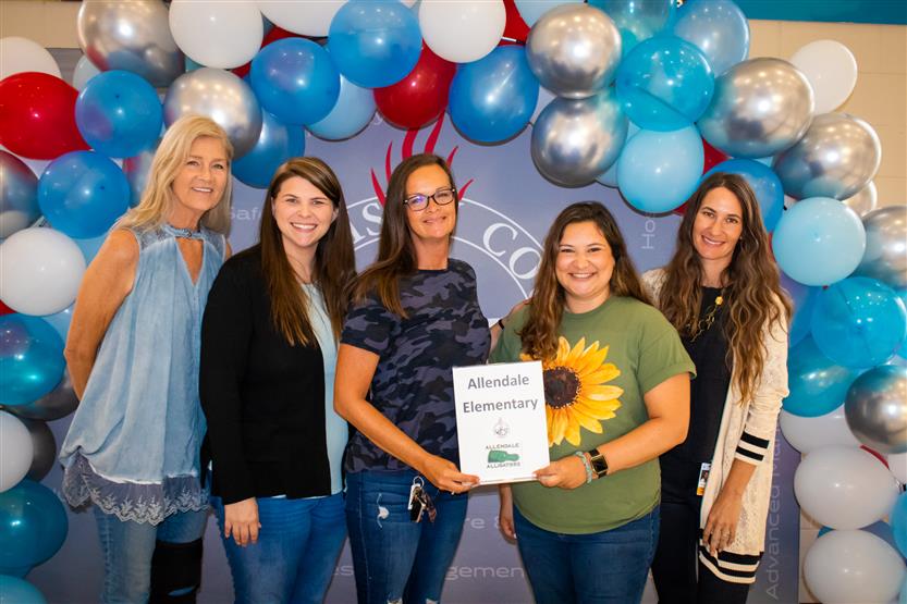 A group of teachers smile